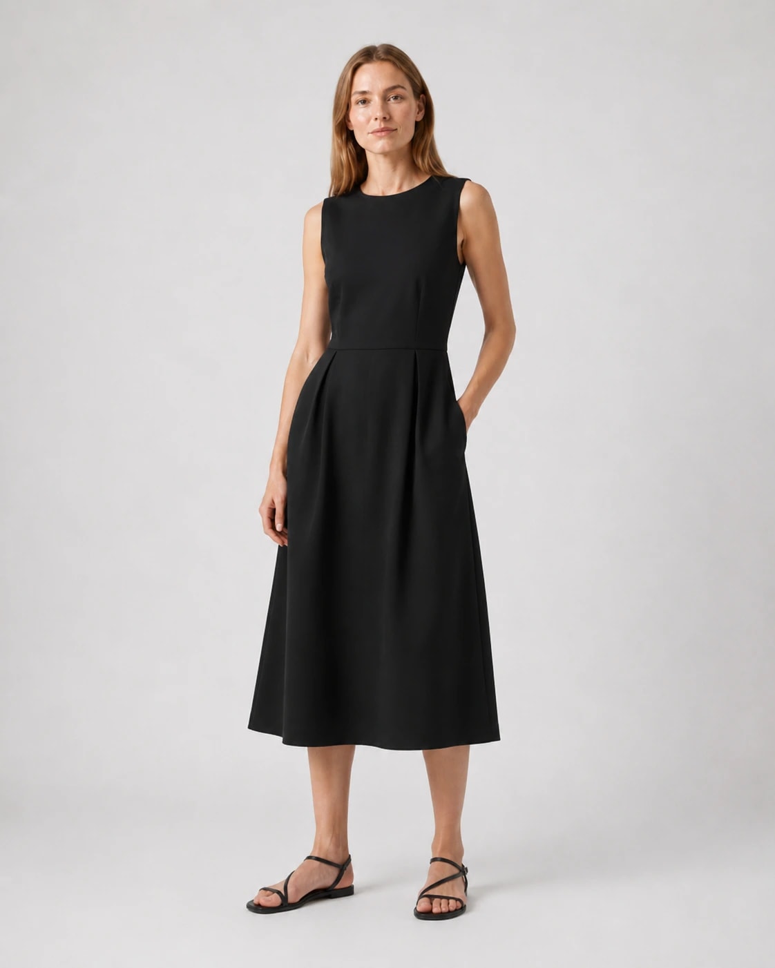 Rochie midi neagră fără mâneci, purtată cu sandale